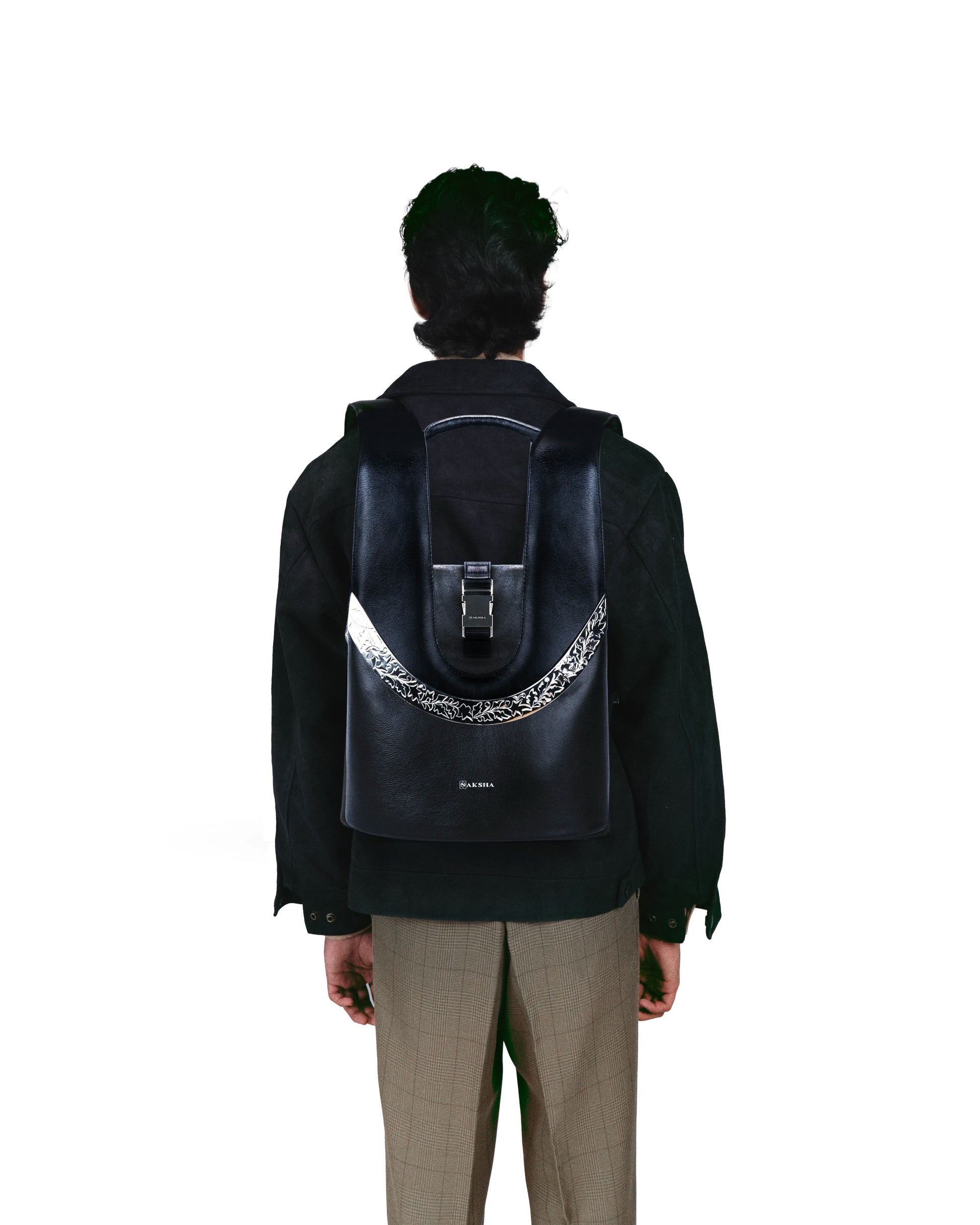 Structured full-grain leather mini backpack with elegant curved silhouette