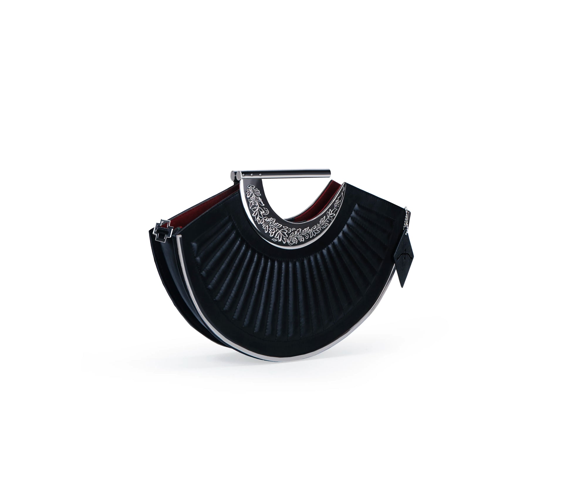 Structured silhouette with curved metal detail — luxury bag design