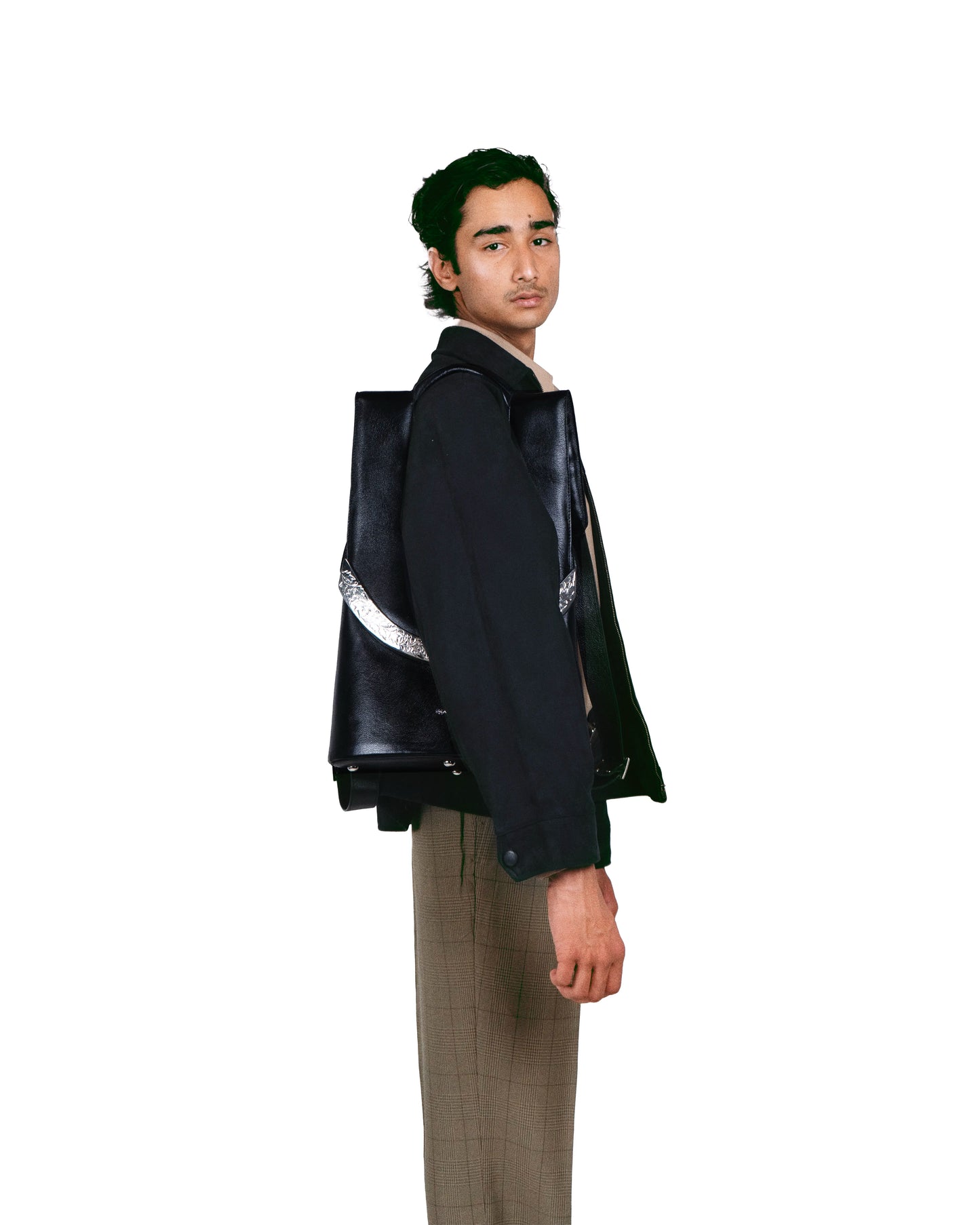 Close-up of engraved arch motif hardware — jewelry-grade detail