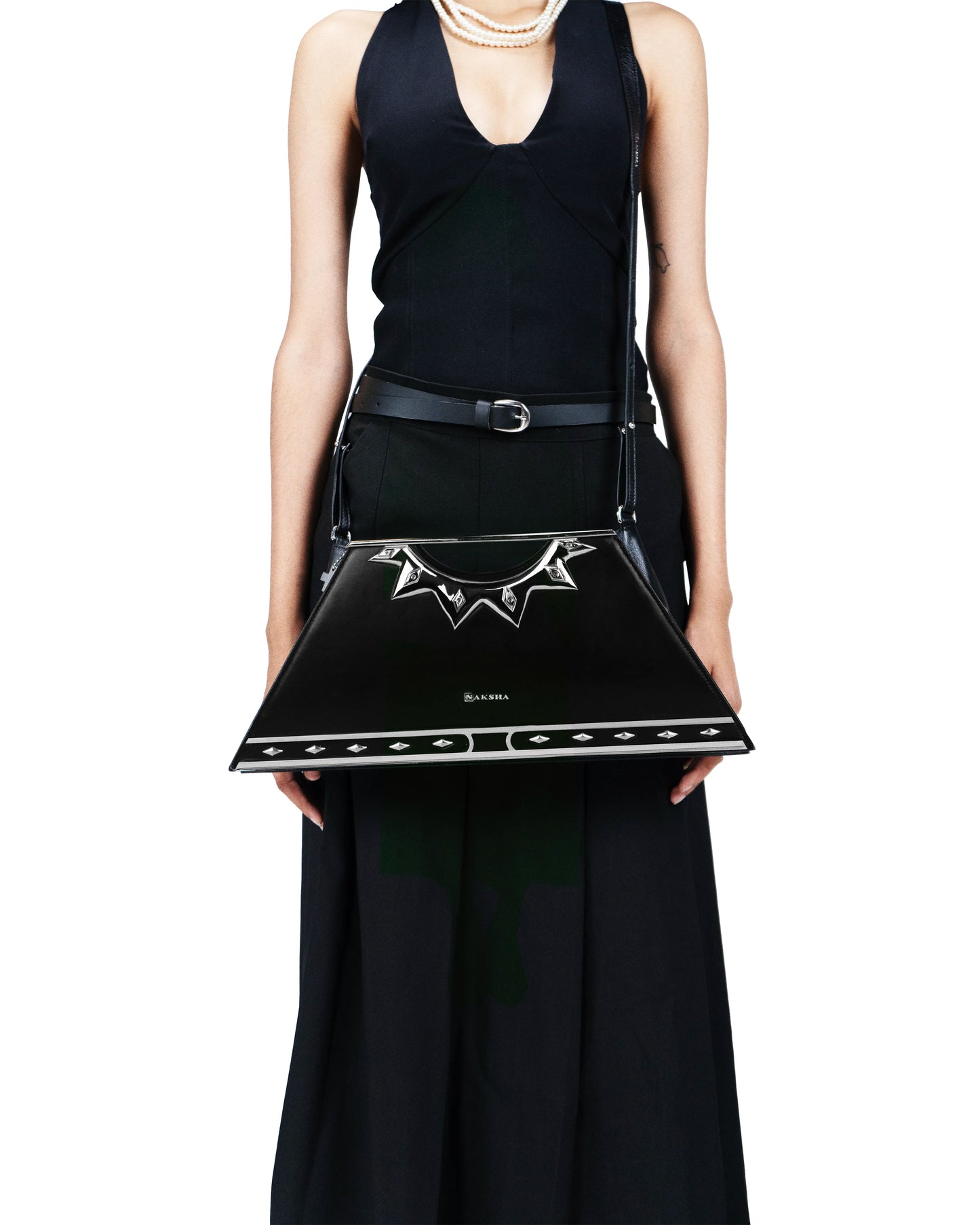 Sculptural silver handle resembling a radiant sun bangle