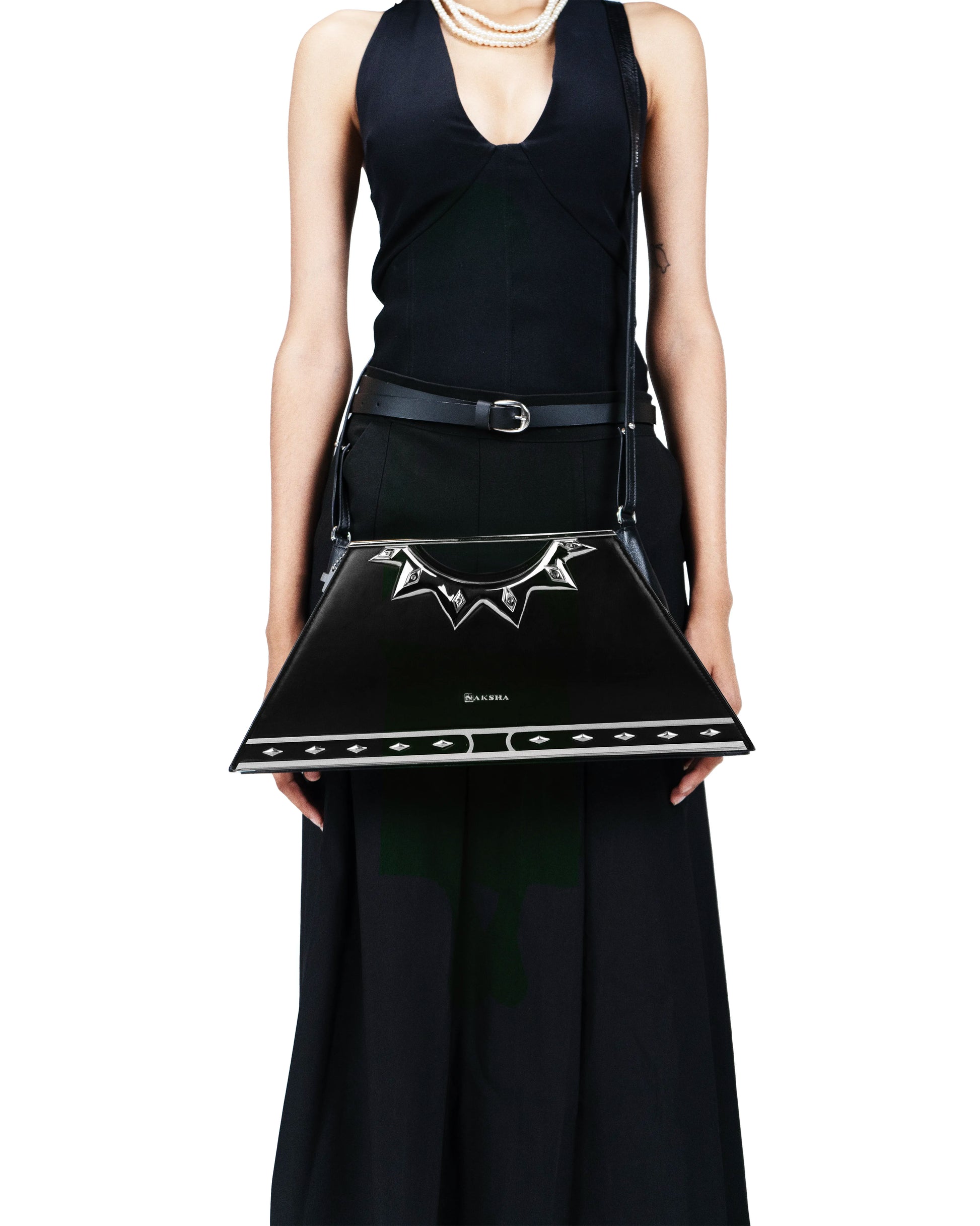 Sculptural silver handle resembling a radiant sun bangle