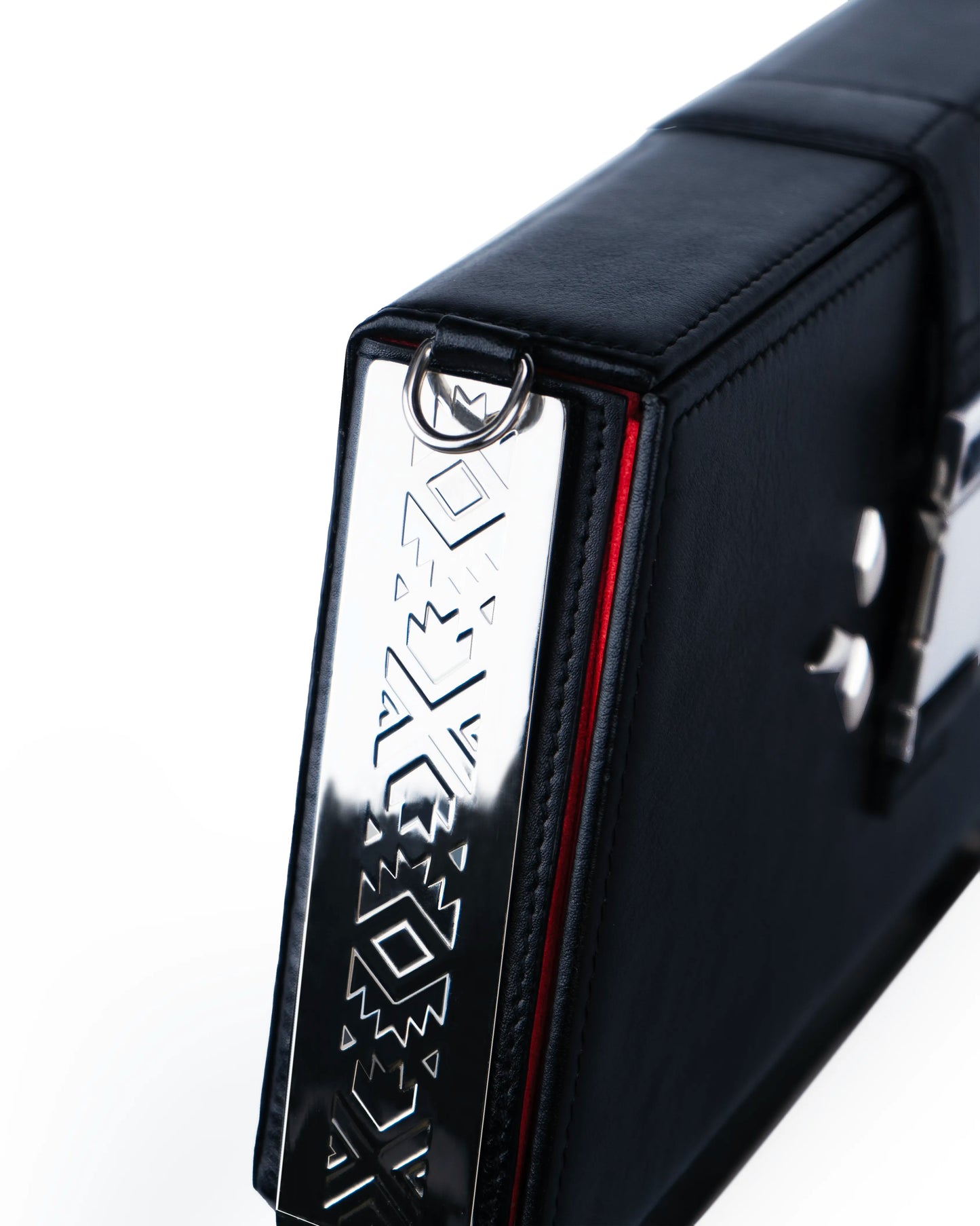 Engraved metallic frame detail — collectible designer trunk