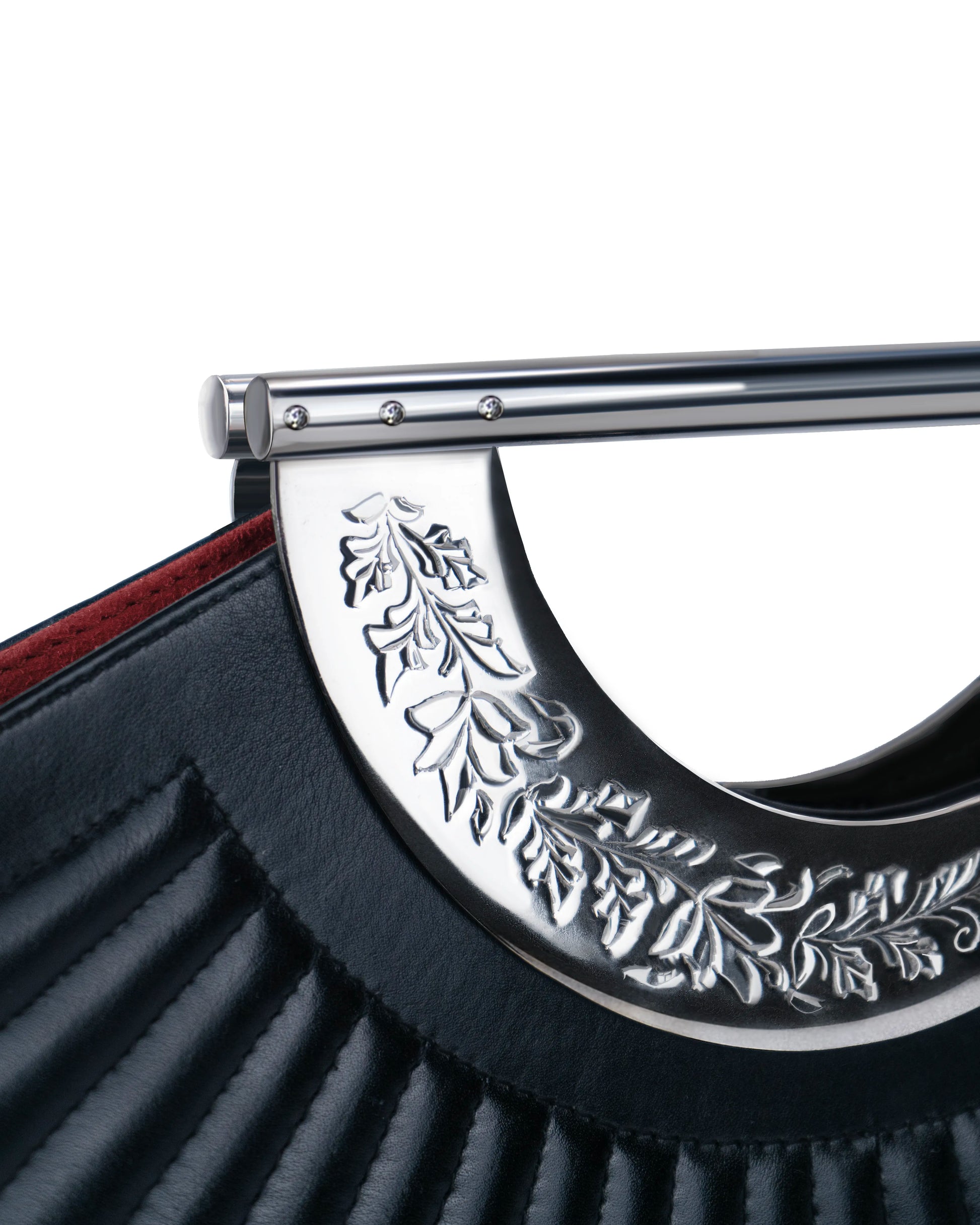 Heritage hand-engraved silver hardware on Sickle designer bag