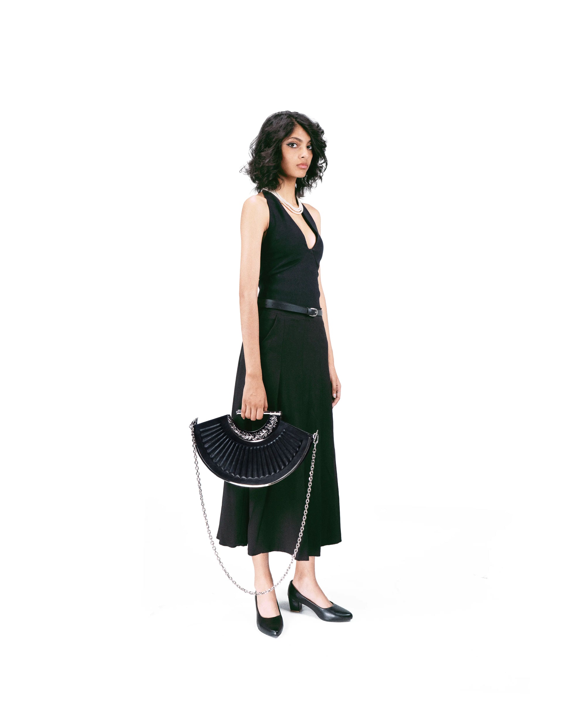Model carrying silver-handled designer shoulder bag